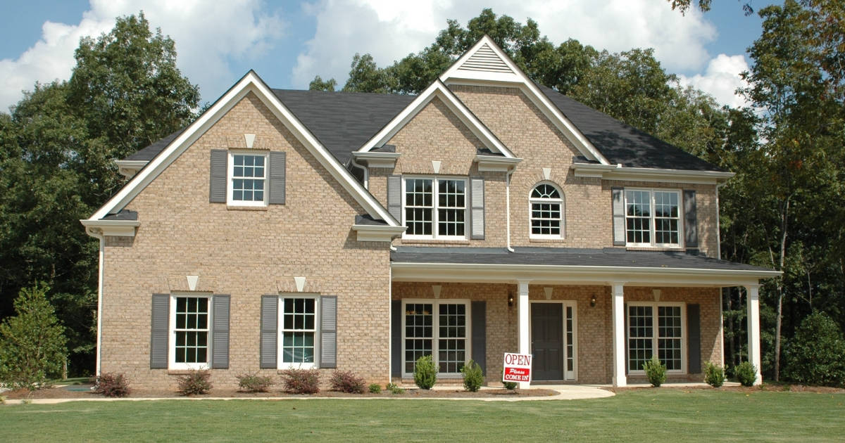 a large house sitting on land shows the trust cost of home ownership