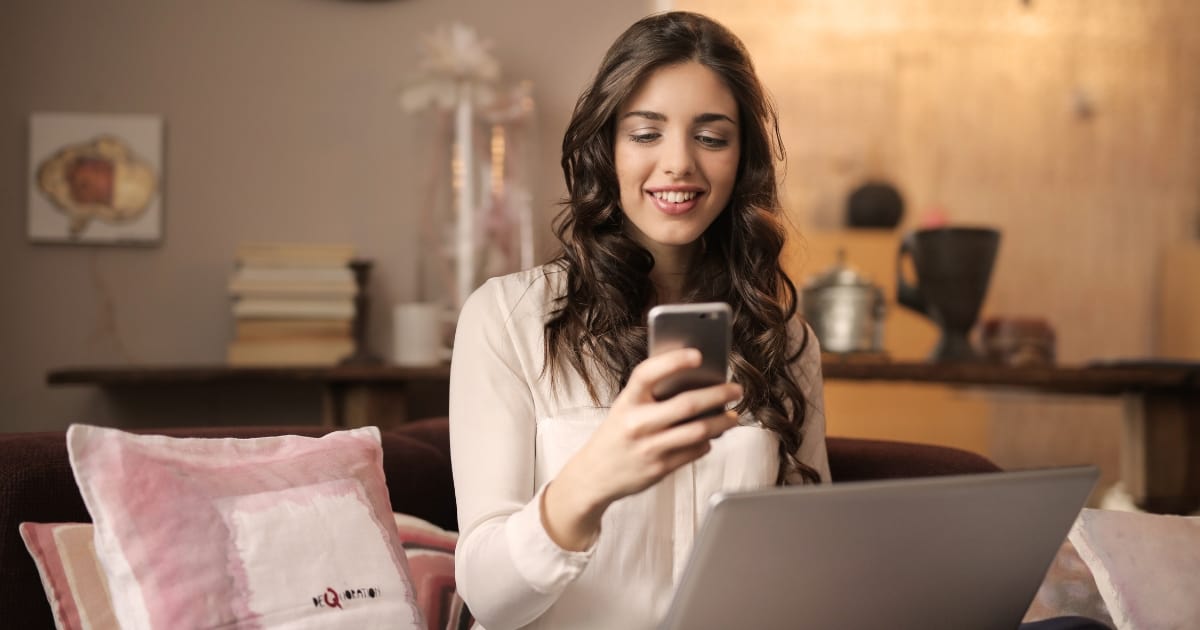 work at home goals woman working from cell phone and laptop