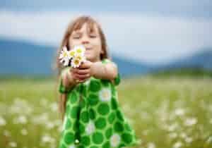 Cute girl giving flowers