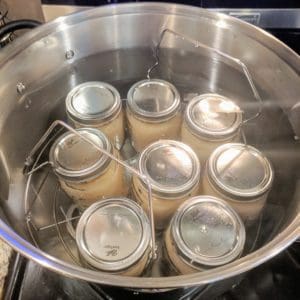 Applesauce mason jars in hot water canning bath