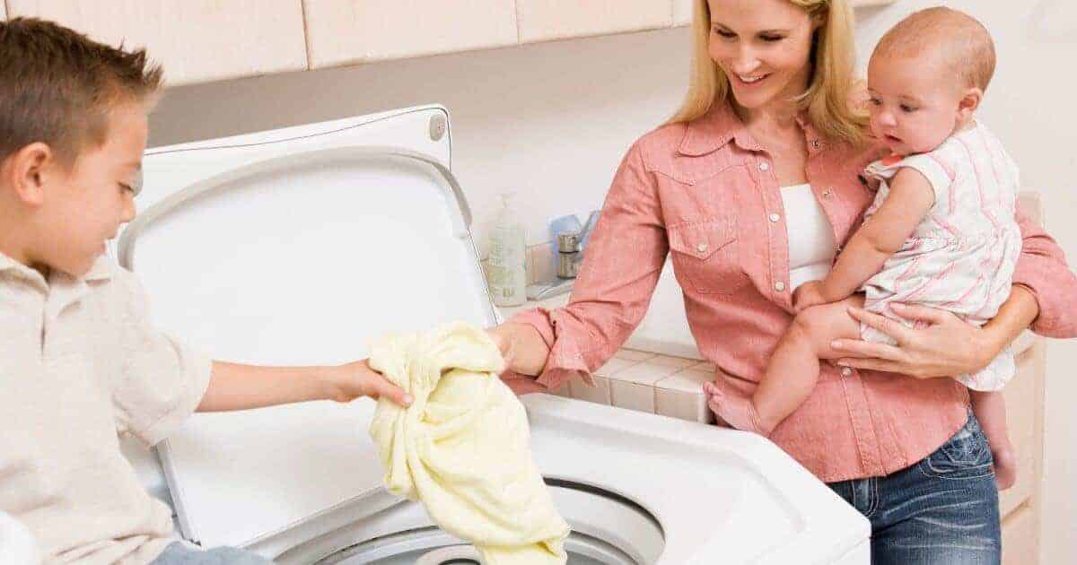 Woman doing laundry with her children