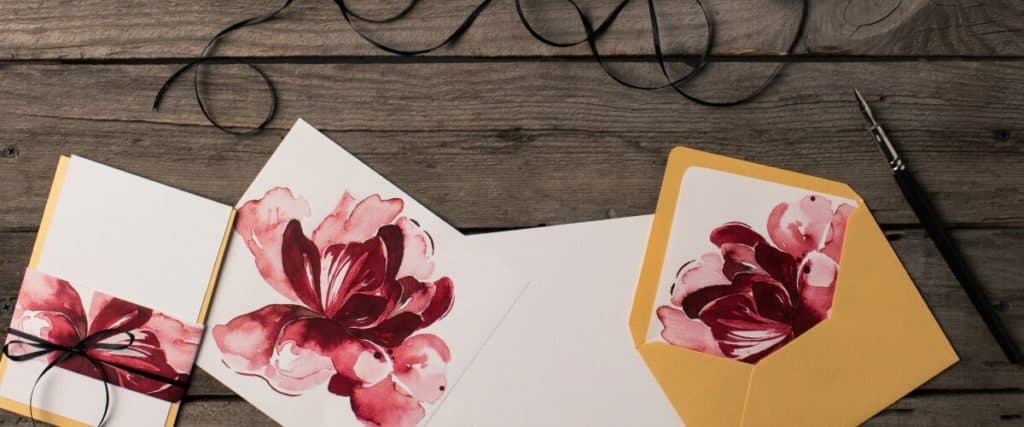 Sample invitations designed with flowers by a graphic designer