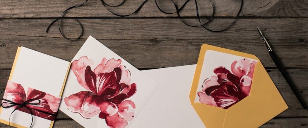 Sample invitations designed with flowers by a graphic designer