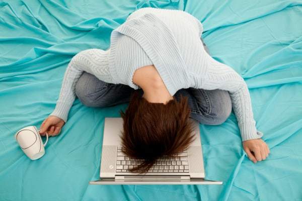 Face your fears - Woman with head on laptop