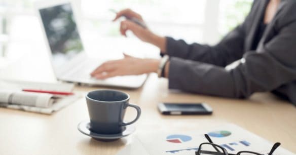 woman sitting at computer working on her finances after divorce