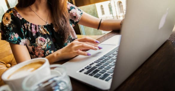 freelancer working in coffee shop on laptop