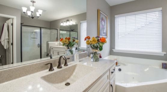 clean white bathroom with flowers on vanity