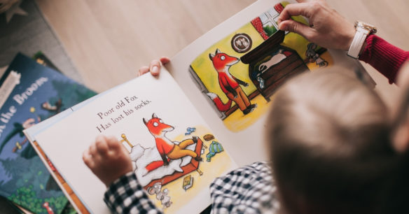 mom and child reading book with pictures together for Read Across America Day