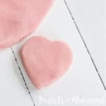 heart shaped glitter playdough on wooden surface