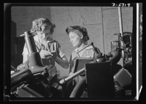 Women in industry. Tool production. Pioneers of the production line, these two young workers are among the first women ever to operate a centerless grinder, a machine requiring both the knowledge of precision measuring instruments, and considerable experience and skill in setting up.