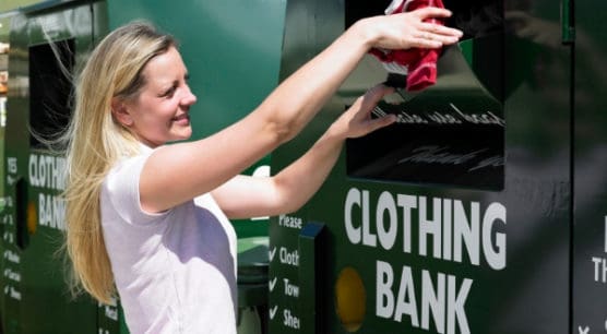 woman donating clothing to a drop off location as part of strategy to prepare to file taxes