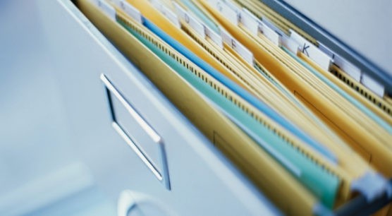 open filing cabinet drawer with paperwork to prepare to file taxes