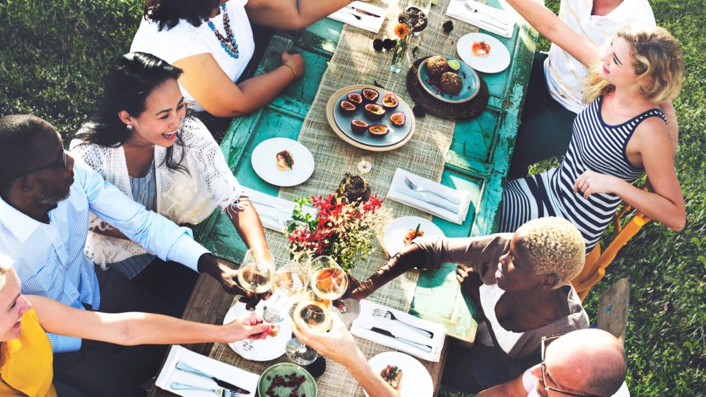 Neighbors having dinner together outside