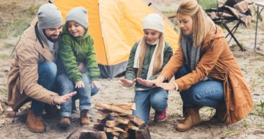 camping with young children around campfire