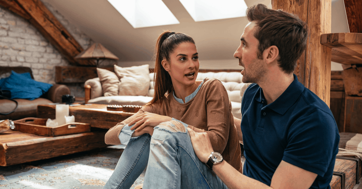 Couple sitting on the floor talking